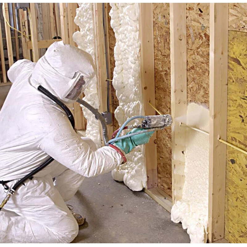 Técnico operario especialista proyectando aislamiento de poliuretano dentro de una cámara de madera para aislar una pared de madera