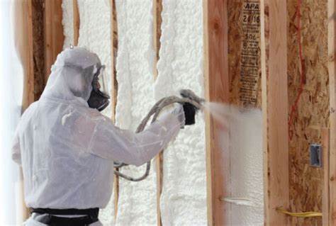 Técnico proyectando espuma de poliuretano en el interior de una cámara de madera para aislarla y ganar así eficiencia energética y aislarla del calor, el frío y la humedad